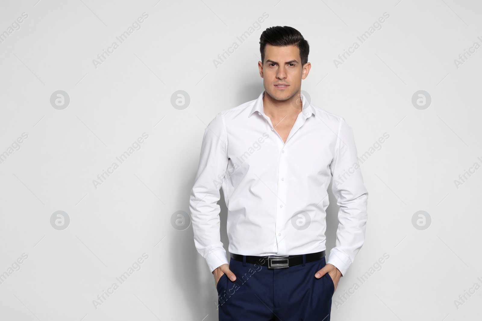 Photo of Portrait of handsome man on light background. Space for text