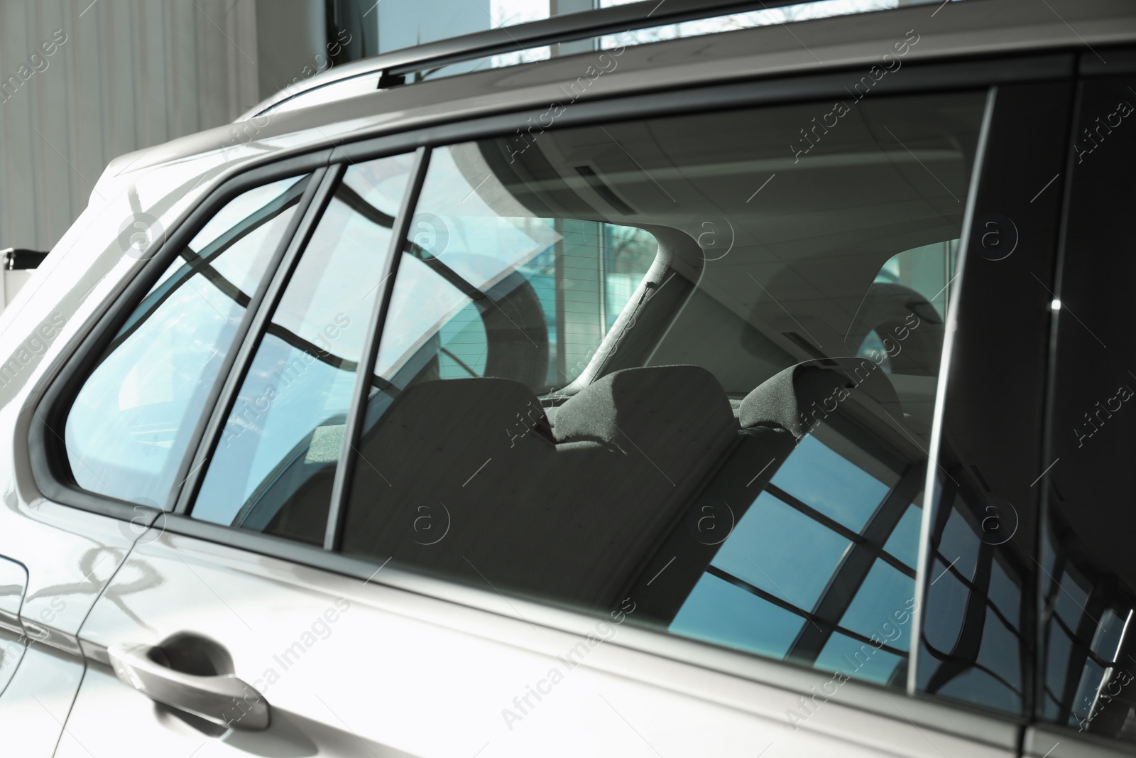 Photo of Modern car with tinting foil on window, closeup