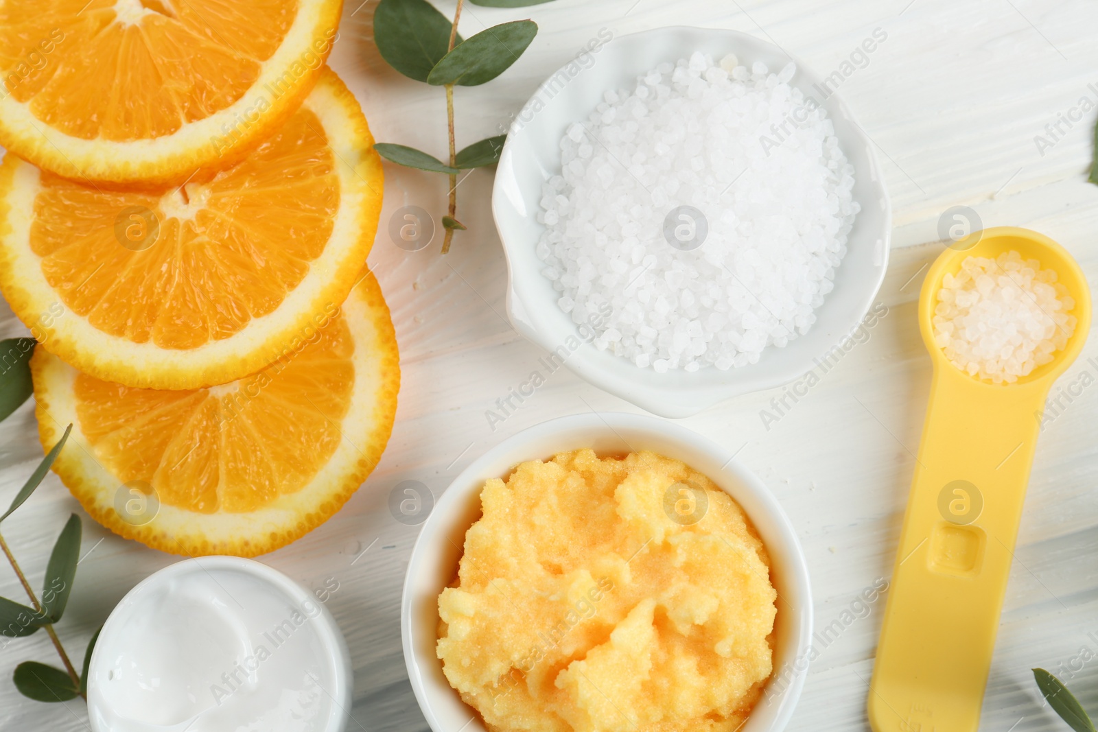 Photo of Homemade cosmetic products and fresh ingredients on white wooden table, flat lay