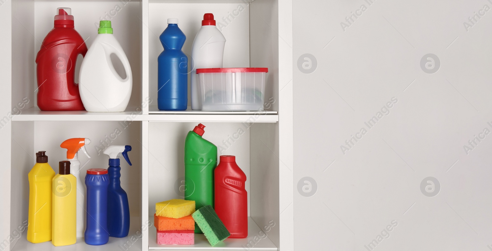 Photo of Different cleaning supplies and sponges on shelves