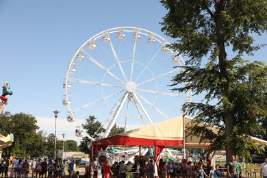 Darlowo, Poland - July 31 2022: Beautiful amusement park with ferris wheel on sunny day