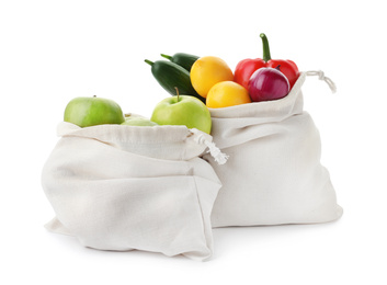 Photo of Cotton eco bags with fruits and vegetables isolated on white