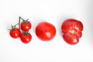 Photo of Many different ripe tomatoes on white background, flat lay
