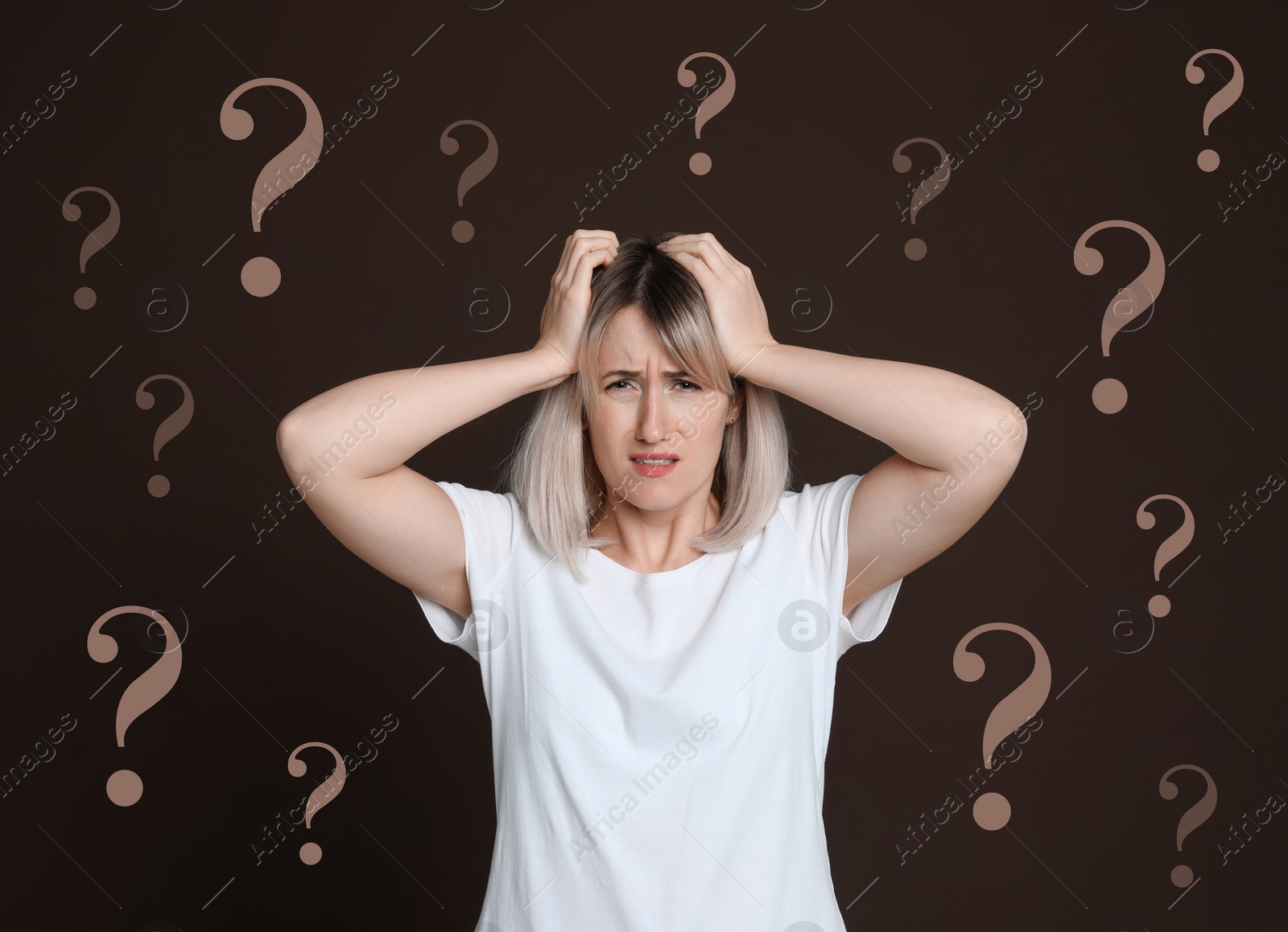 Image of Amnesia. Confused woman and question marks on brown background