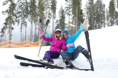 Couple of skiers on slope at resort. Winter vacation