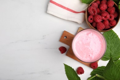 Photo of Tasty raspberry smoothie in glass and fresh berries on white marble table, flat lay. Space for text