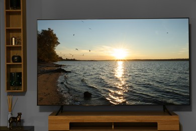 Image of Tv with nature show on screen in room