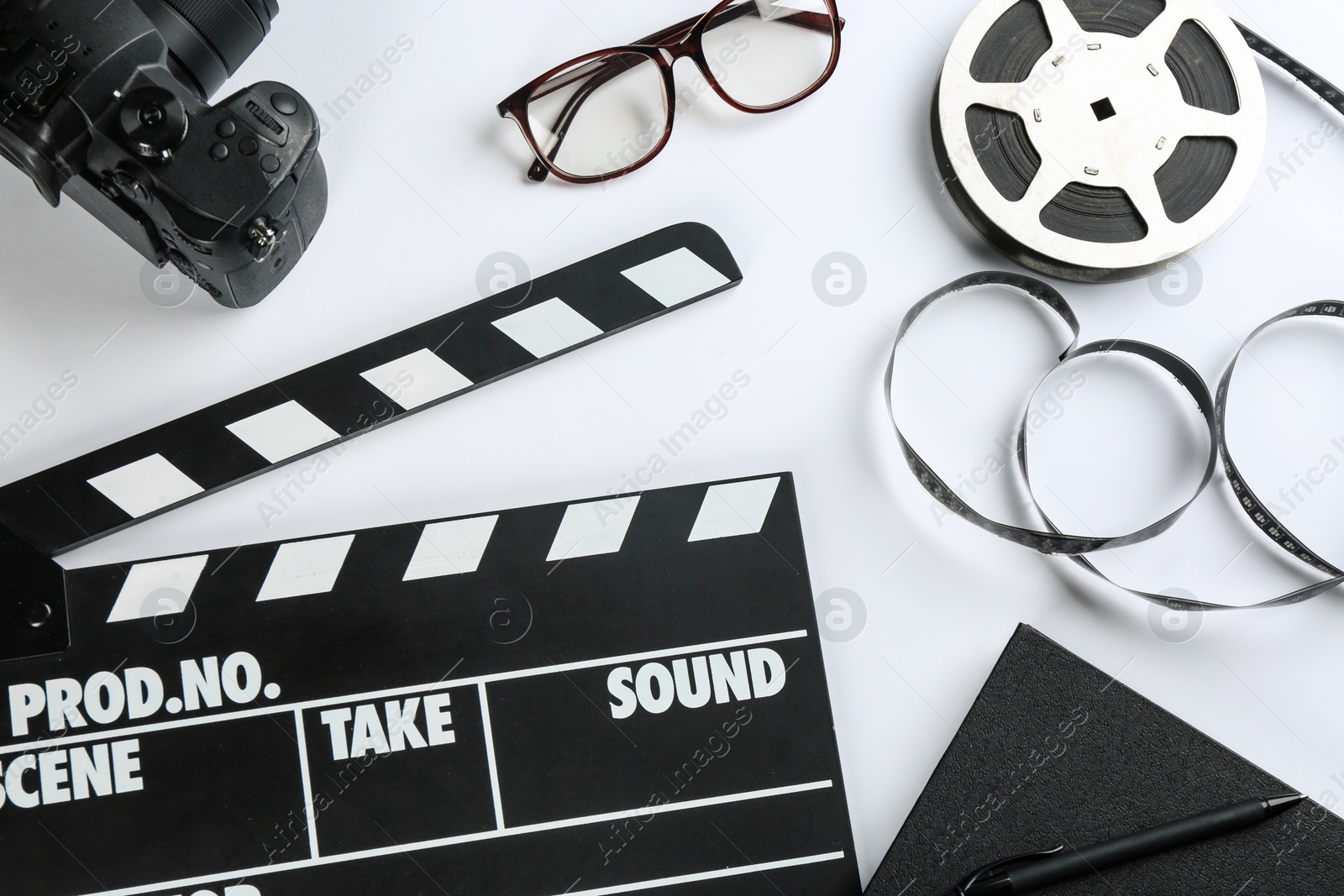Photo of Composition with camera and clapboard on white background, top view. Video production industry