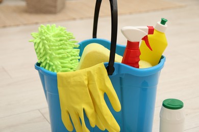 Photo of Different cleaning products and bucket on floor indoors