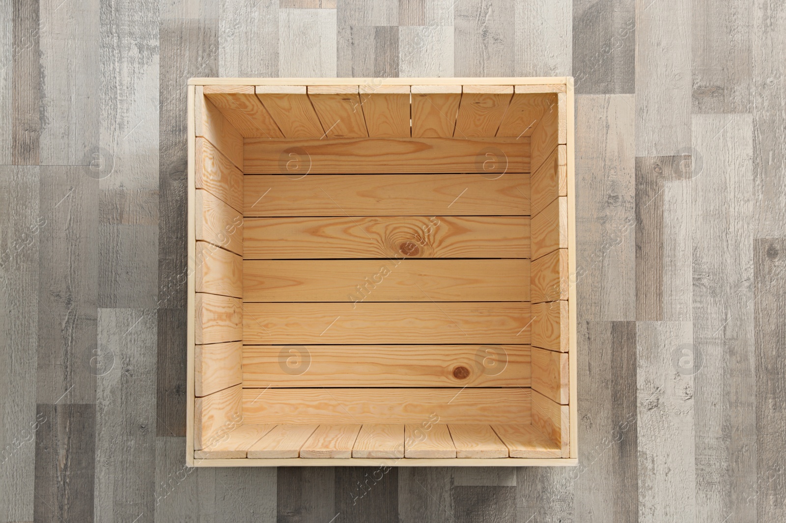 Photo of Open wooden crate on floor, top view