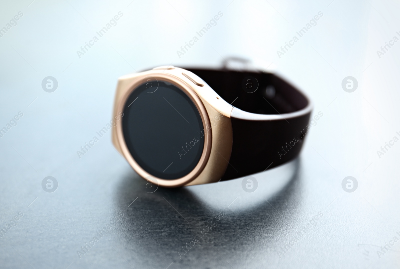 Modern stylish smart watch on grey table, closeup Photo of Modern stylish smart watch on grey table, closeup
