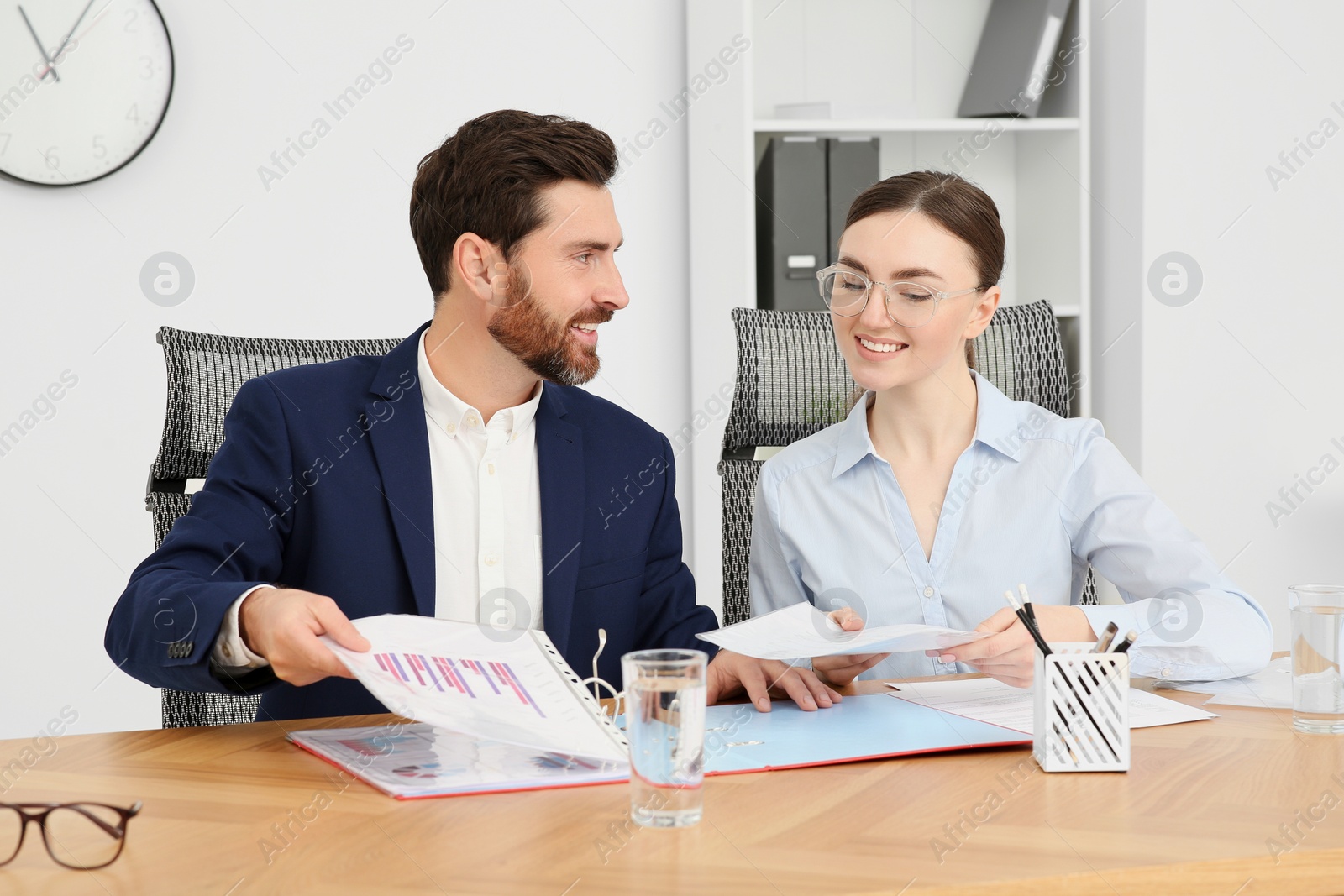 Photo of Businesspeople working together with documents in office