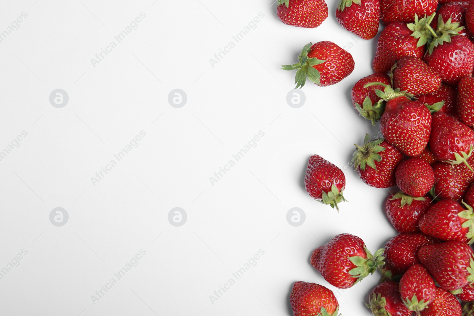 Photo of Tasty ripe strawberries on white background, flat lay. Space for text