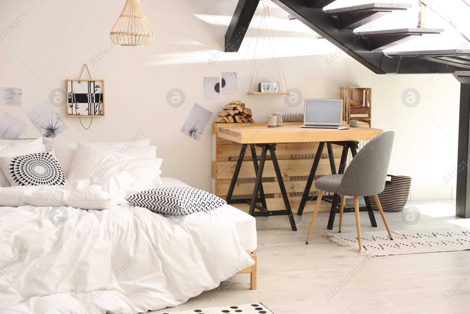 Photo of Elegant interior of bedroom with workplace under stairs