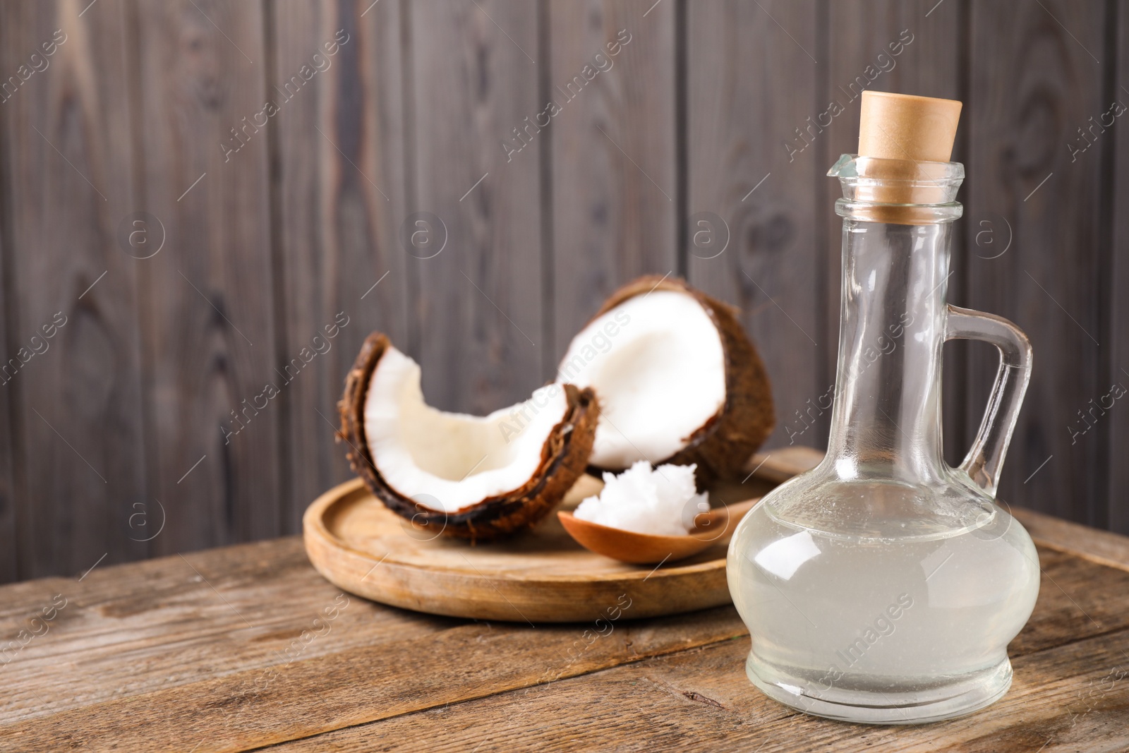 Photo of Coconut oil on wooden table. Space for text