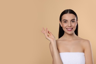 Photo of Portrait of attractive young woman on beige background, space for text. Spa treatment