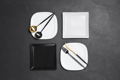 Photo of Flat lay composition with tableware on black background