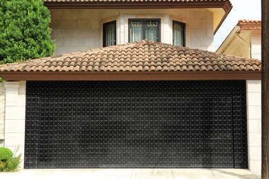 Photo of Black metal garage gates on building outdoors