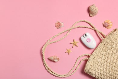 Photo of Beach bag, epilator and seashells on pink background, flat lay. Space for text