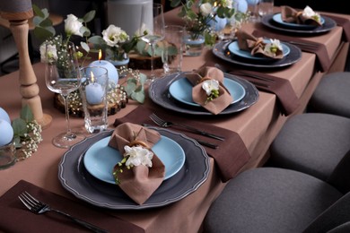 Elegant table setting with beautiful floral decor and burning candles