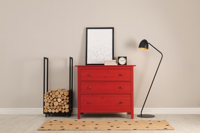 Photo of Modern room interior with chest of drawers near light wall