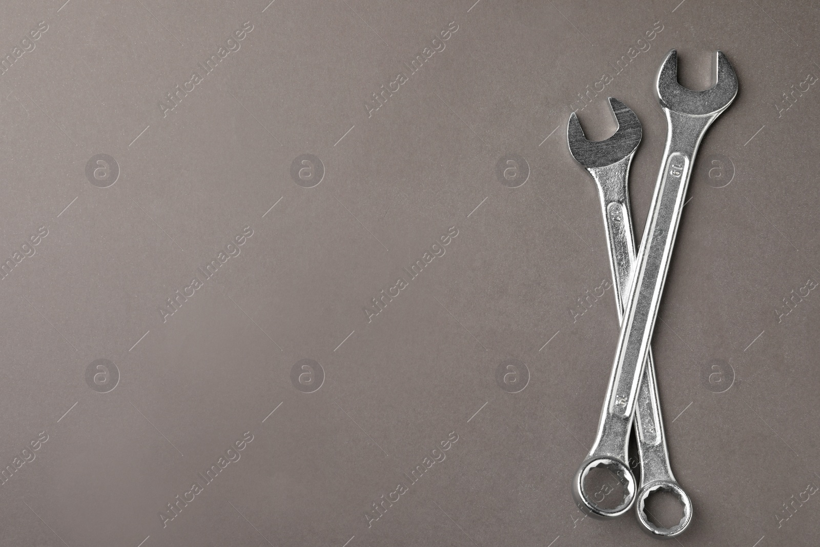 Photo of Auto mechanic's tools on grey background, flat lay. Space for text