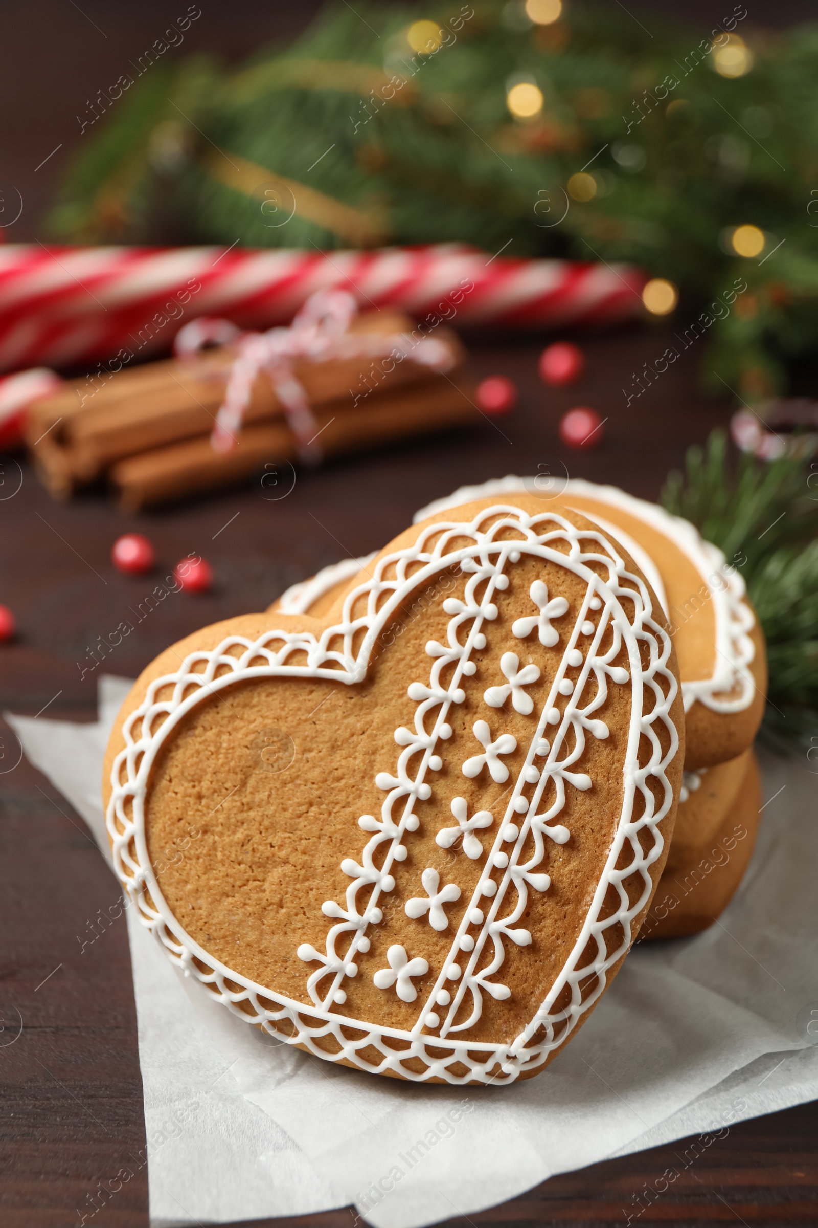 Photo of Tasty heart shaped gingerbread cookies on wooden table, closeup