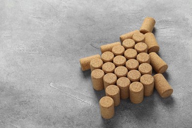 Photo of Christmas tree made of wine corks on grey table. Space for text