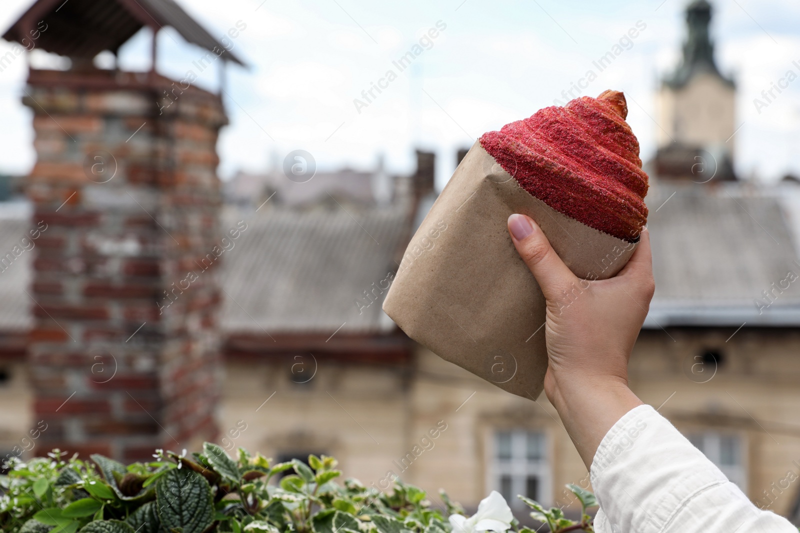 Photo of Woman with delicious croissant outdoors, closeup. Space for text