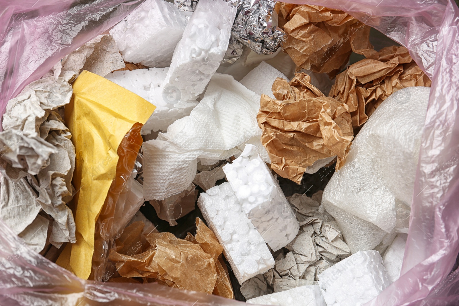 Photo of Pile of different garbage as background, top view. Recycling problem