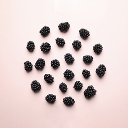 Photo of Tasty ripe blackberries on light background, flat lay