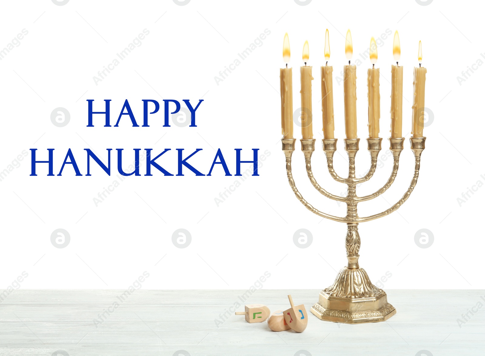 Image of Happy Hanukkah. Traditional menorah and dreidels on wooden table