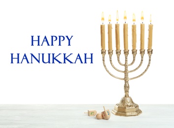 Happy Hanukkah. Traditional menorah and dreidels on wooden table
