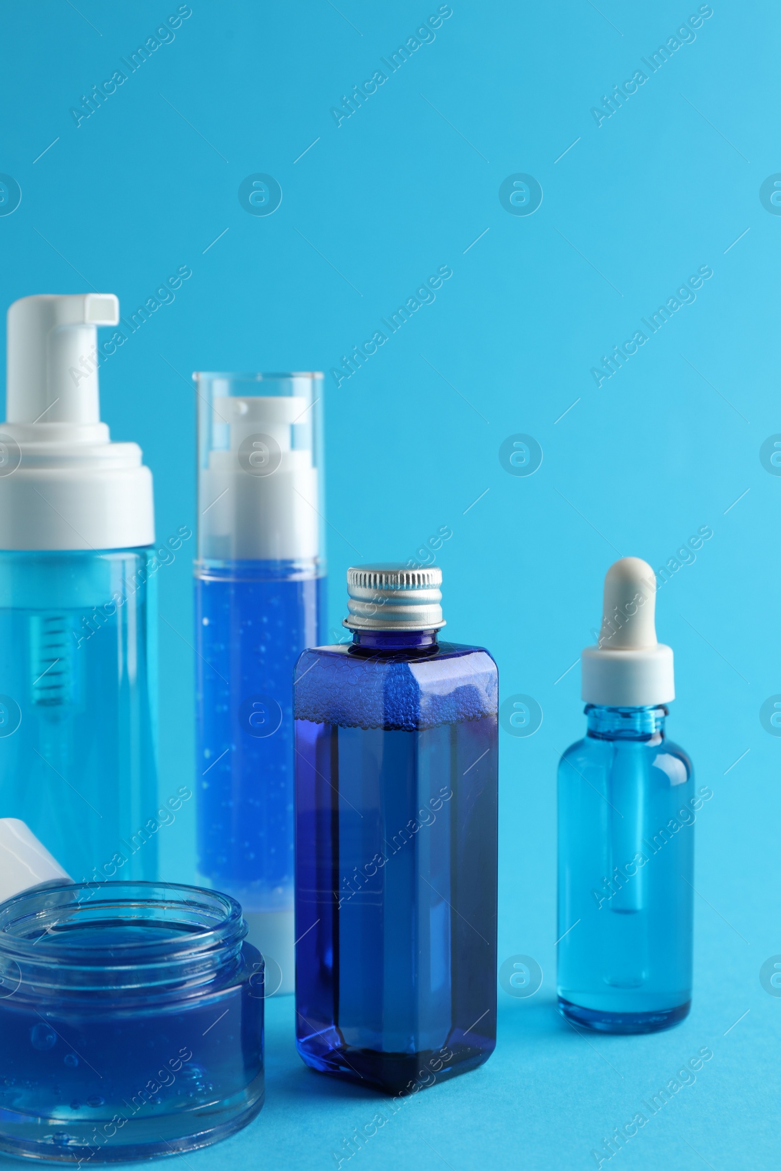 Photo of Set of luxury cosmetic products on light blue background