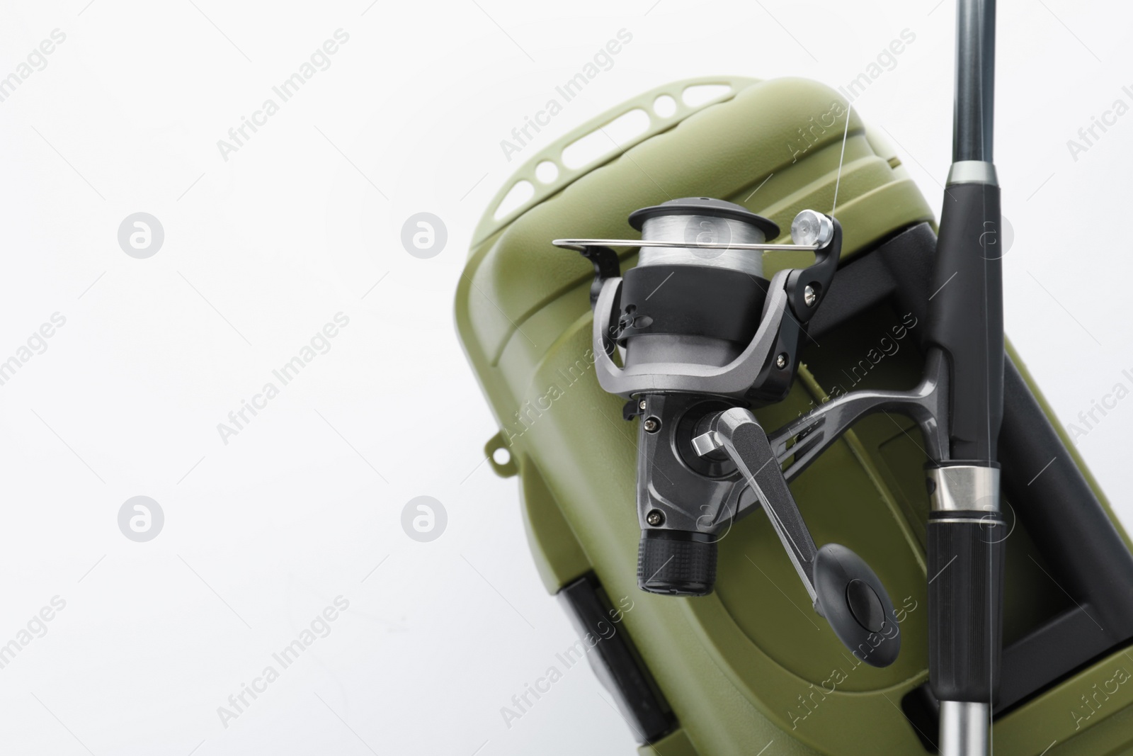 Photo of Box for tackle and fishing rod on white background, above view