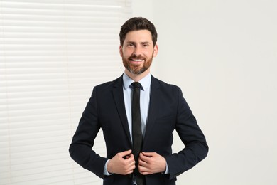 Photo of Handsome real estate agent in nice suit indoors