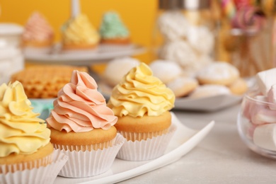 Photo of Tasty cupcakes and other sweets on table. Candy bar, closeup view