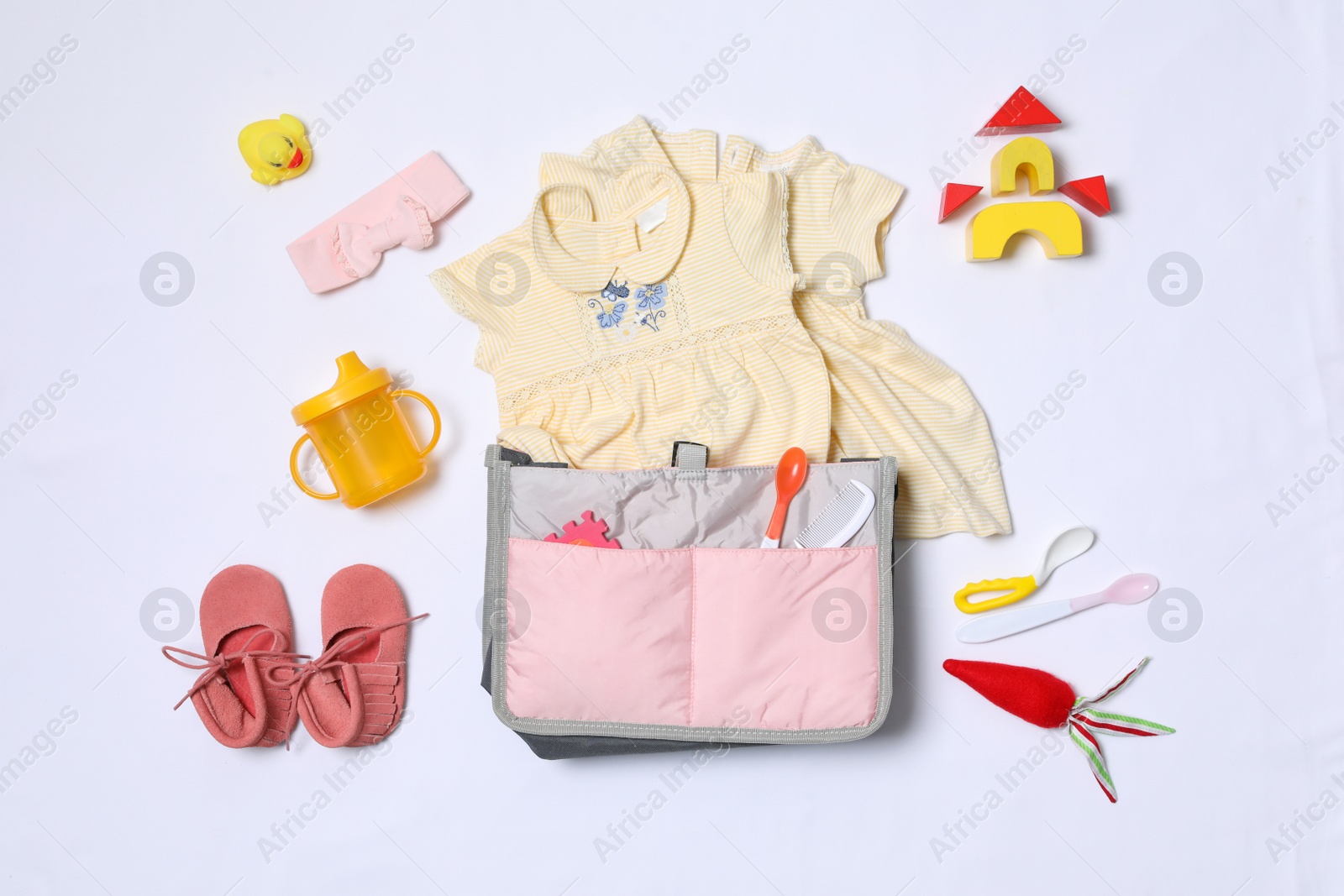 Photo of Composition with maternity bag and baby accessories on white background, top view