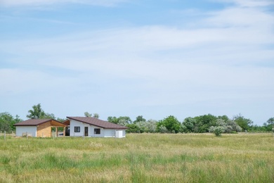 Wooden houses in countryside on sunny day