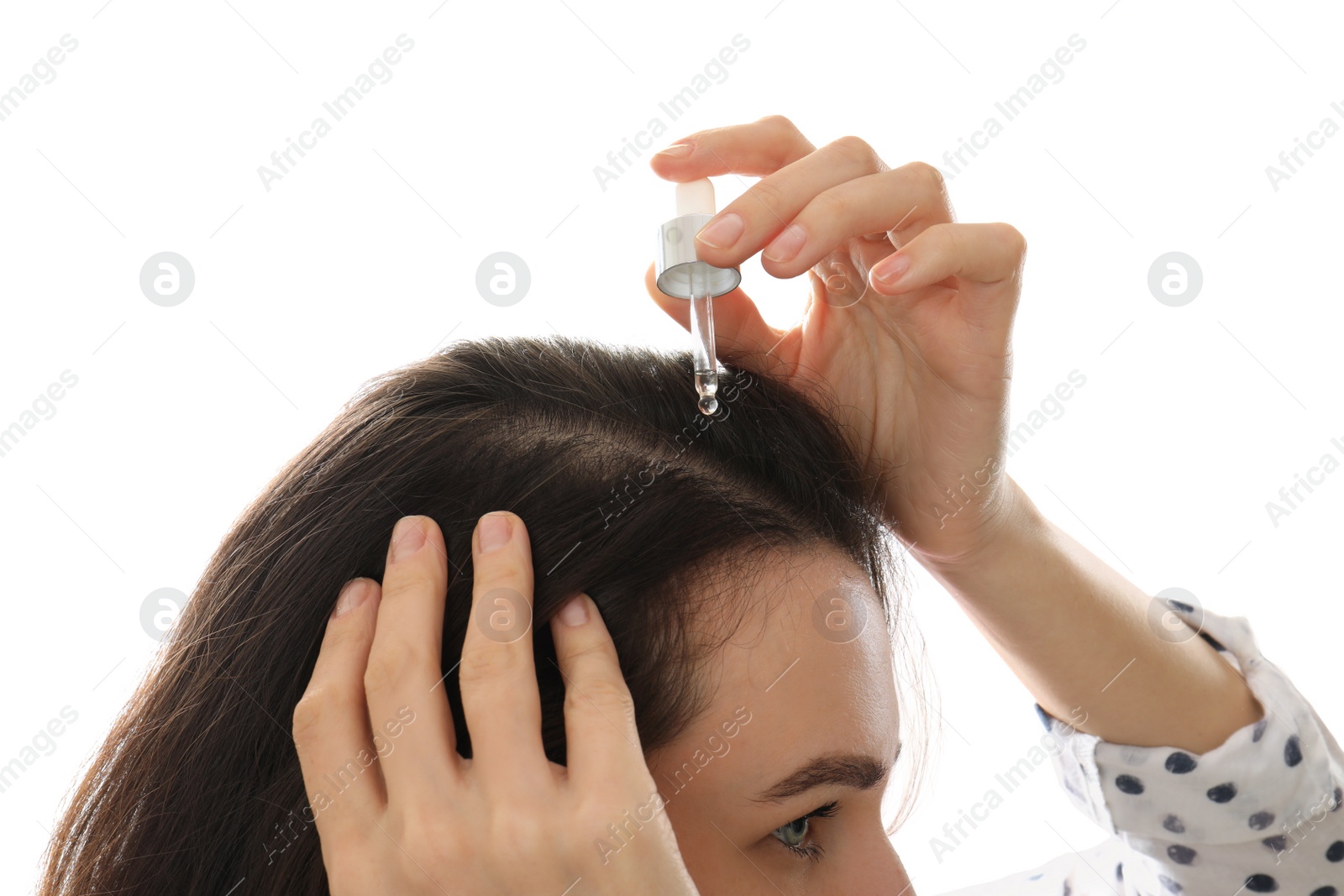 Photo of Woman applying oil onto hair on white background, closeup. Baldness problem