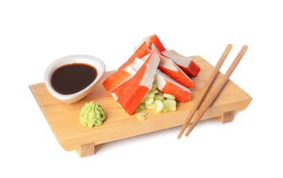 Fresh crab sticks served on wooden board, white background