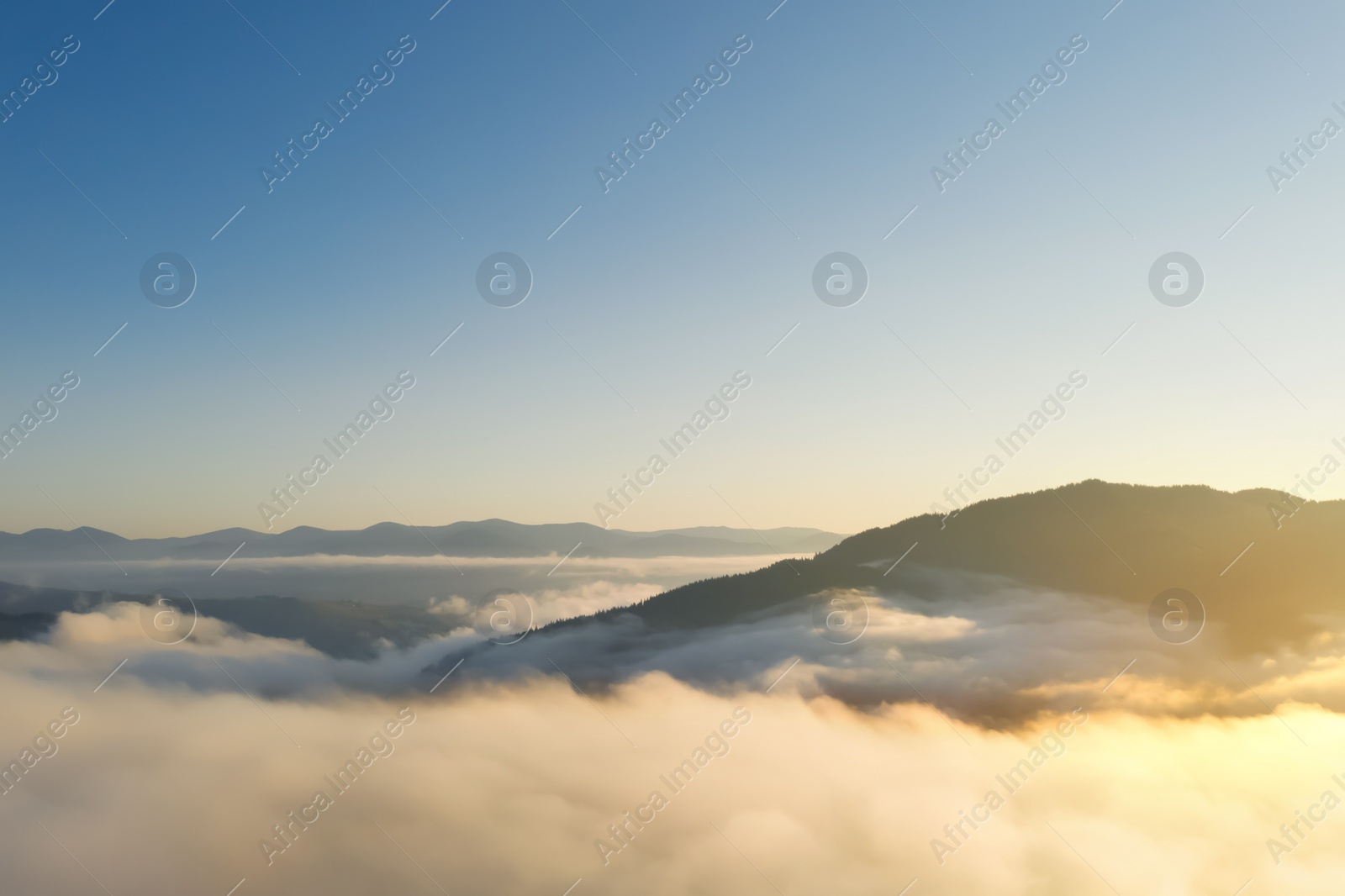 Image of Beautiful landscape with thick mist in mountains. Drone photography