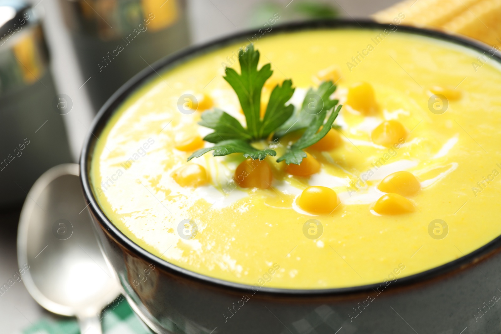 Photo of Delicious creamy corn soup in bowl, closeup