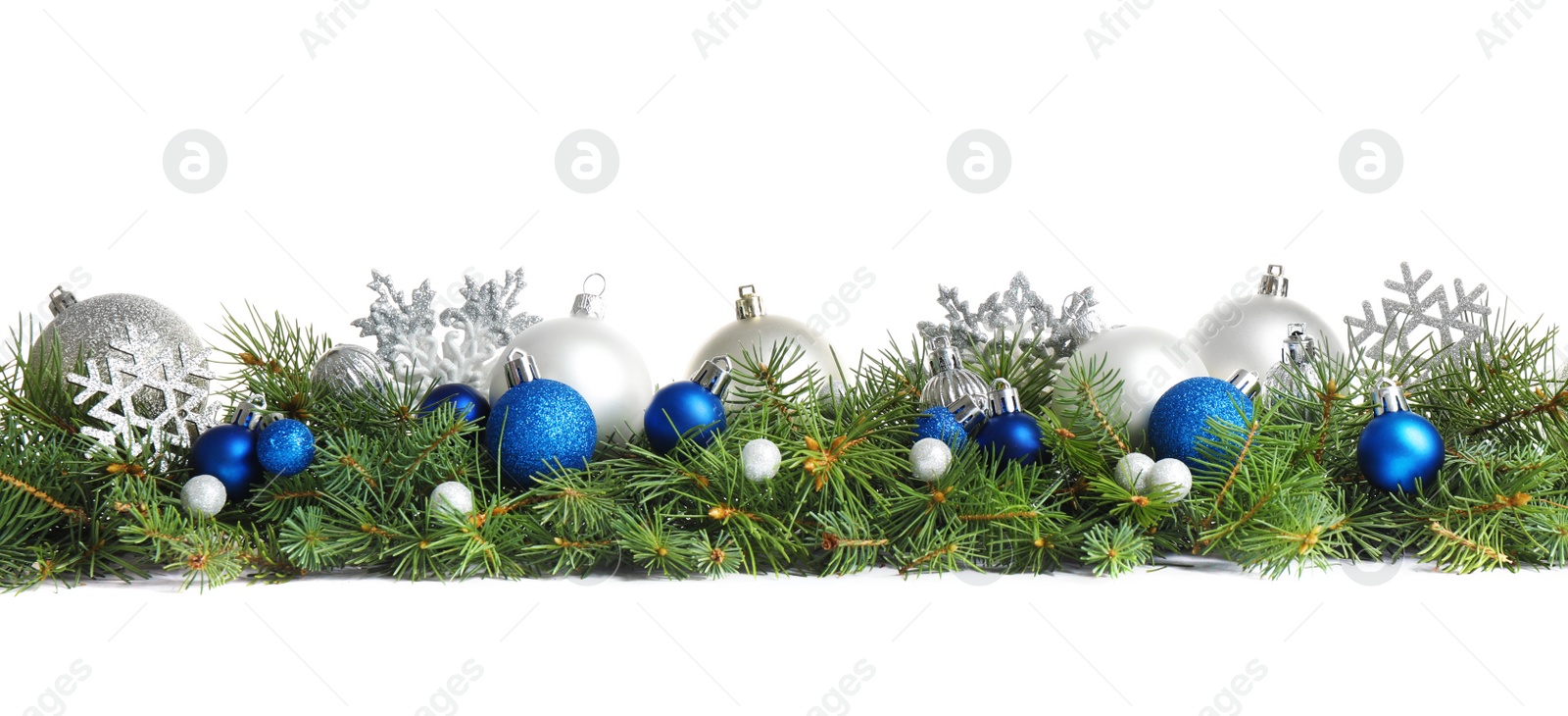 Photo of Fir tree branches with Christmas decoration on white background