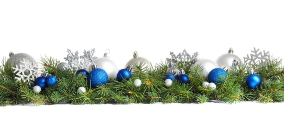 Photo of Fir tree branches with Christmas decoration on white background