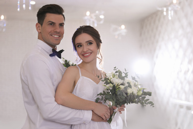 Photo of Happy newlywed couple together in festive hall