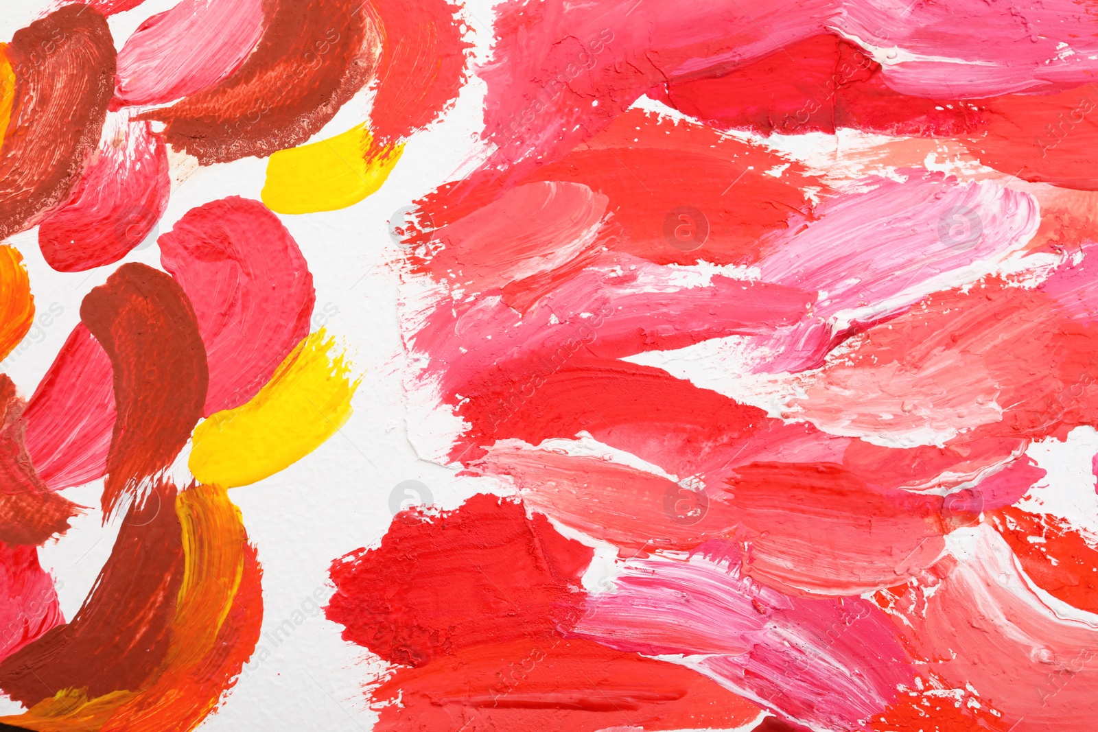 Photo of Beautiful strokes of bright oil paints on white canvas as background, closeup