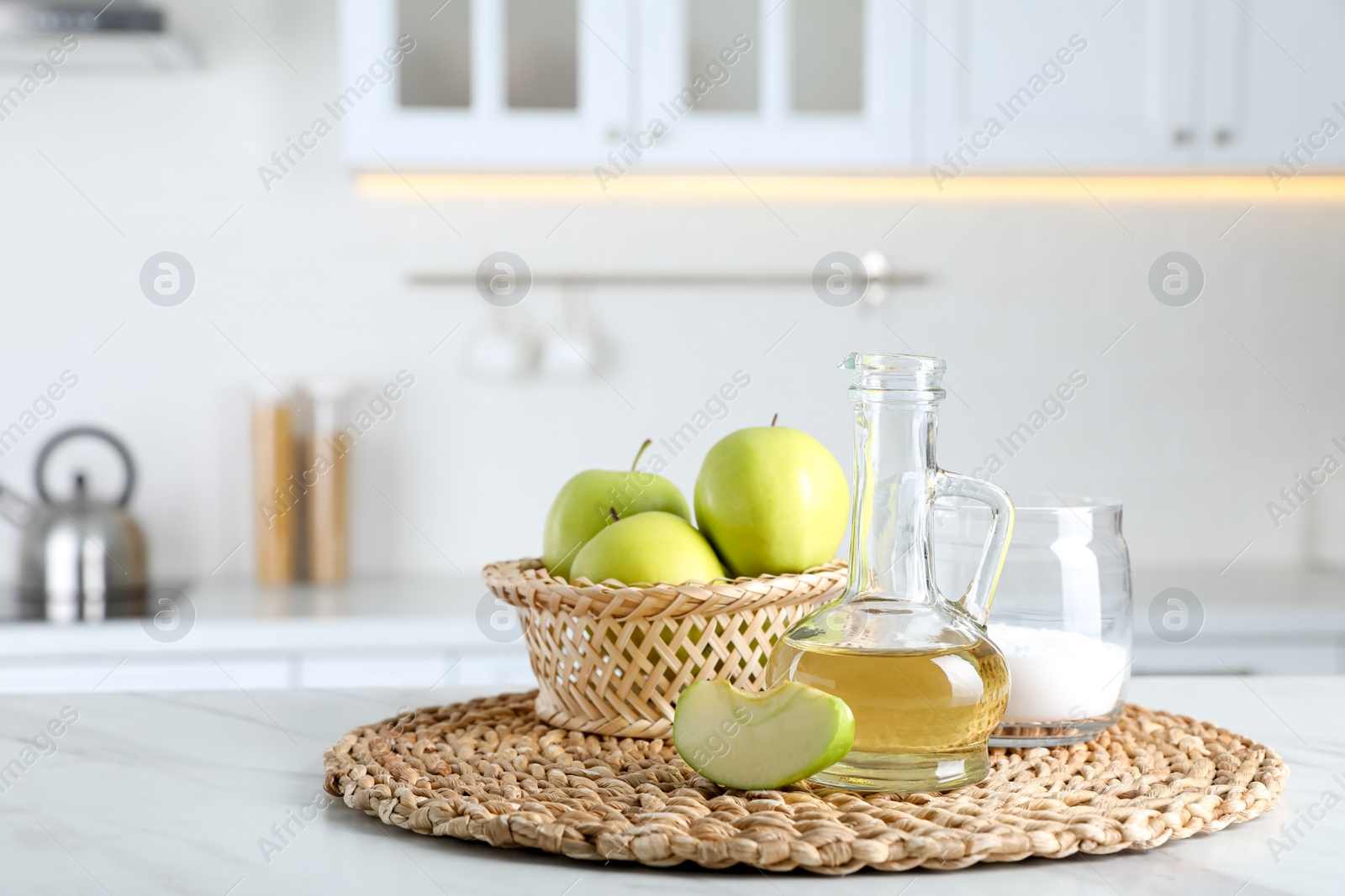 Photo of Apple vinegar and baking soda on white marble table in kitchen. Eco friendly natural detergents