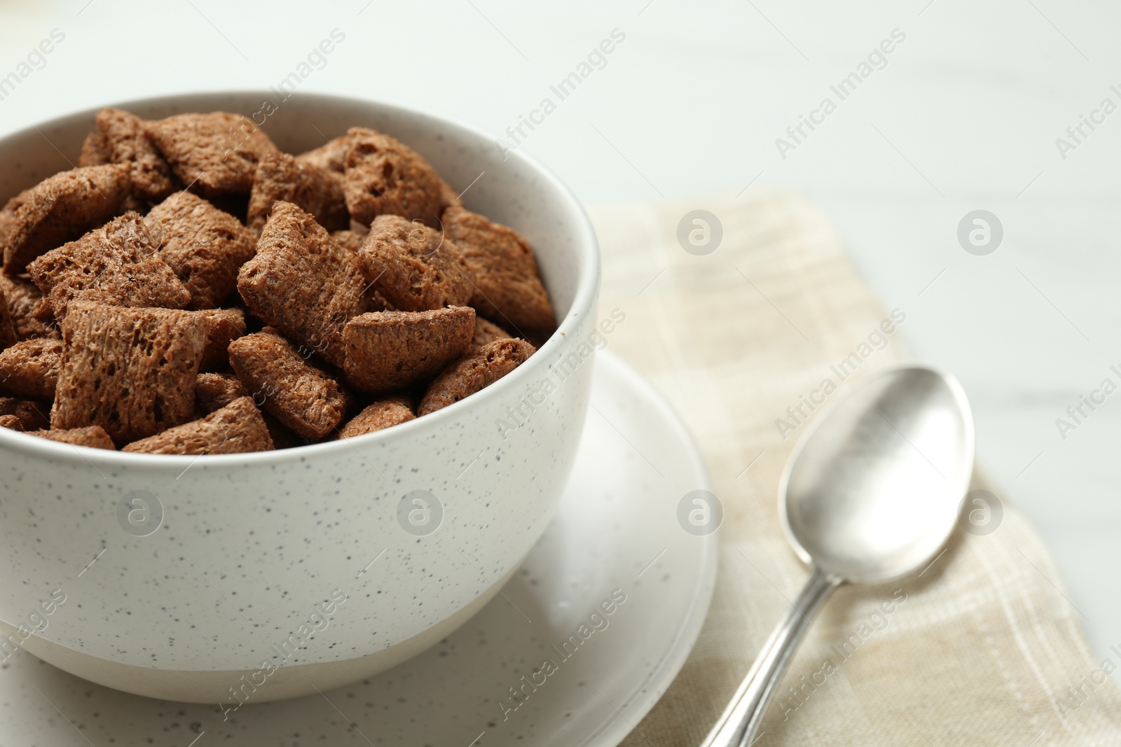 Photo of Bowl of sweet crispy corn pads on kitchen towel, closeup view with space for text. Breakfast cereal