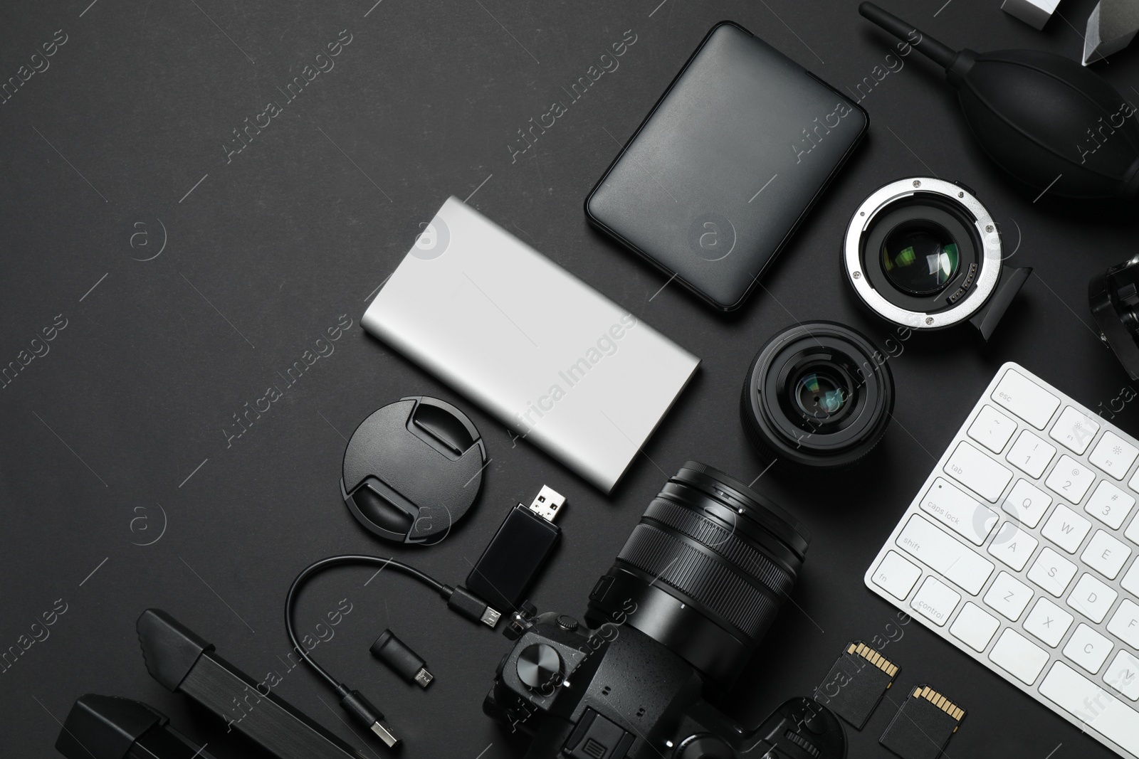 Photo of Camera, video production equipment and computer keyboard on black background, flat lay